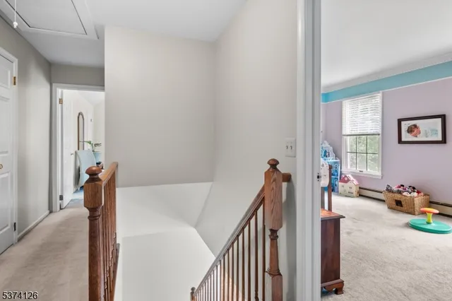 a view of a livingroom with white furniture and stairs
