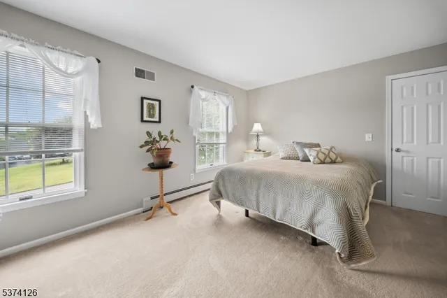 a bedroom with bed and a window