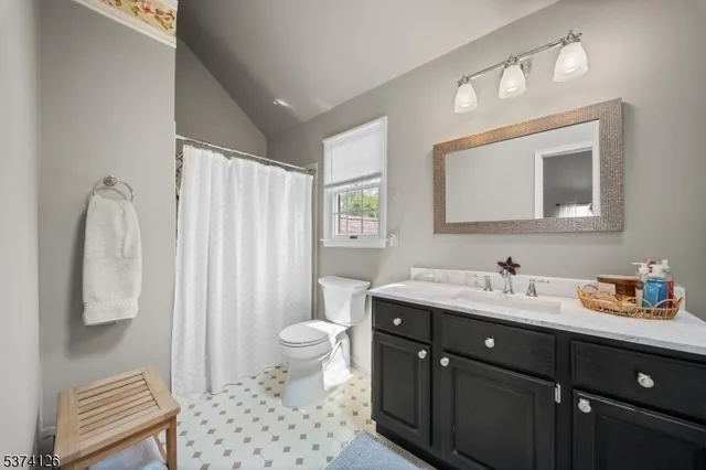 a bathroom with a tub a sink and a large mirror