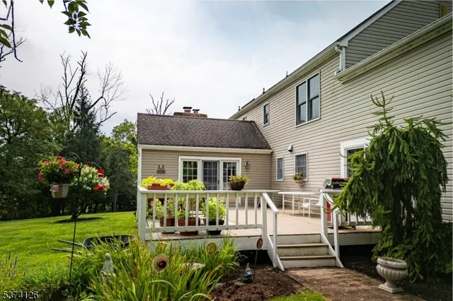 an aerial view of a house with garden space and street view
