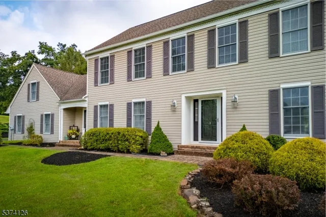 a front view of a house with garden and porch