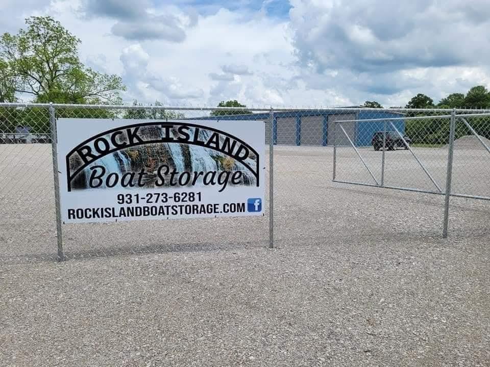 a view of a street sign under a white wall