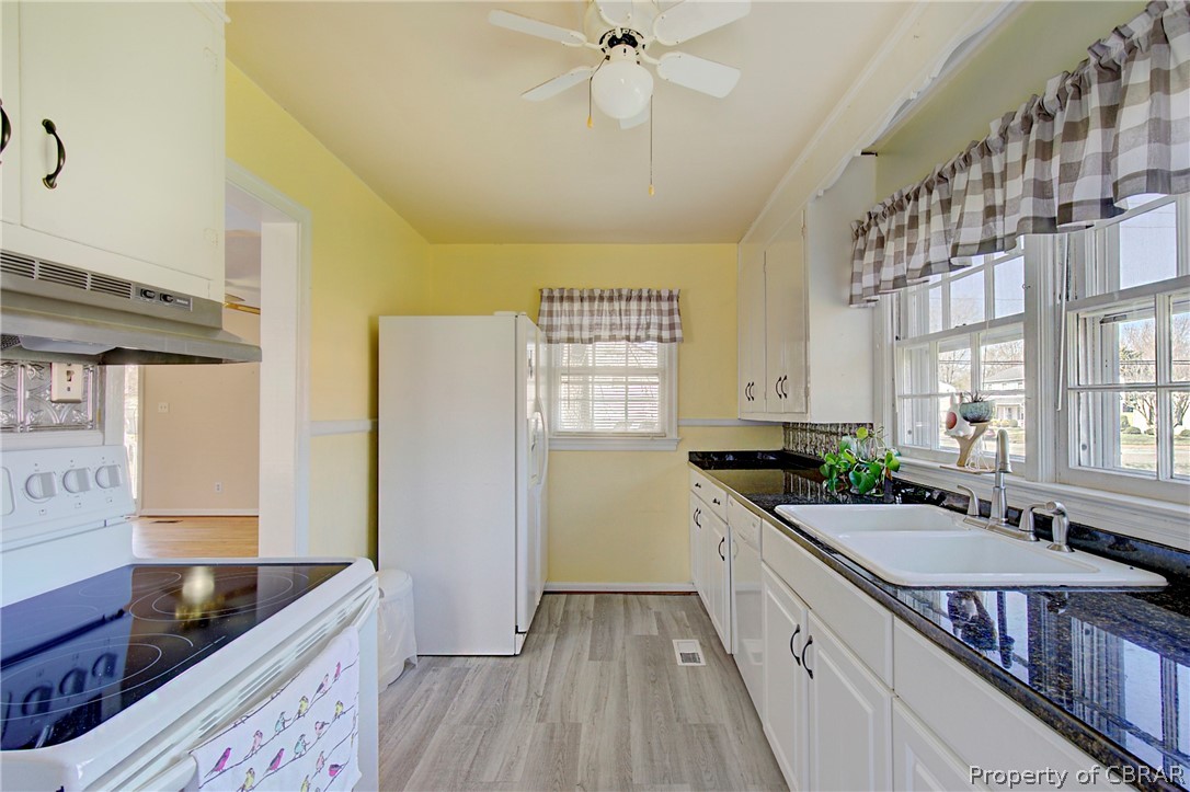 12 Old Meribeth Road Hampton, VA 23669 - Photo 13 of 32 Kitchen with white cabinetry, white appliances, plenty of natural light, and light wood-type flooring