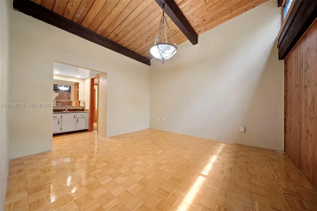 a bathroom with a granite countertop sink a toilet and a mirror