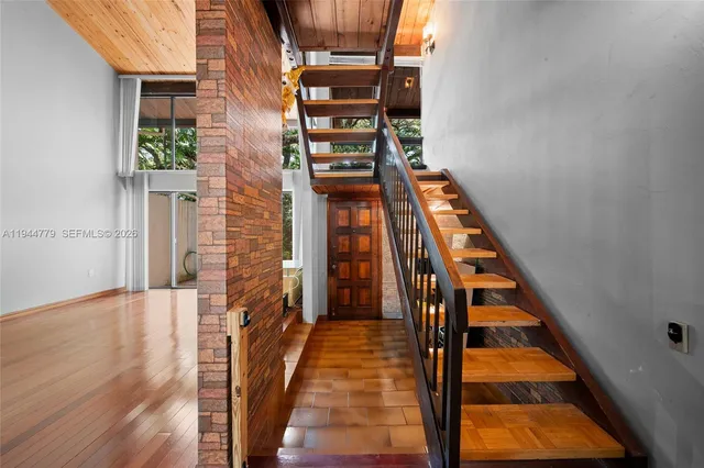 a view of a room with wooden floor