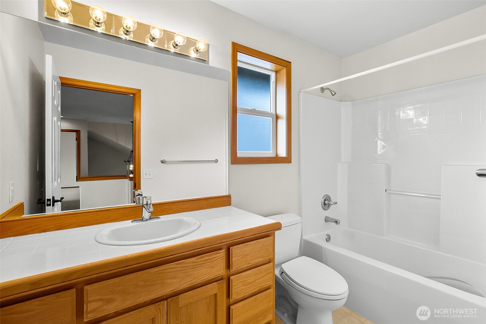 18410 11th Drive Southeast Bothell, WA 98012 - Photo 27 of 40 a bathroom with a sink a toilet a mirror and bathtub