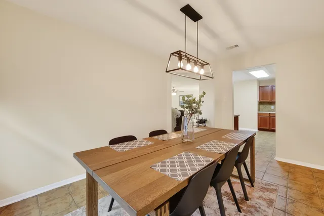 a kitchen with stainless steel appliances granite countertop a stove a sink a microwave and a refrigerator