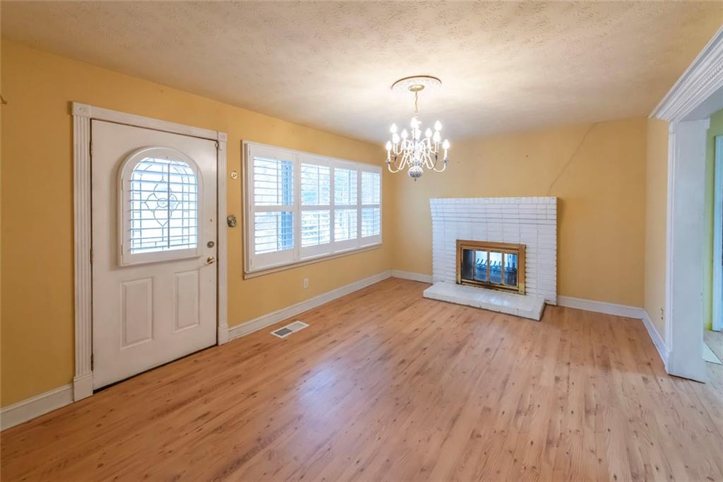 3819 Mason Creek Road Winston, GA 30187 - Photo 14 of 52 a view of an empty room with wooden floor fireplace and a window