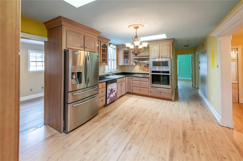 3819 Mason Creek Road Winston, GA 30187 - Photo 17 of 52 a kitchen with stainless steel appliances a refrigerator and wooden floor