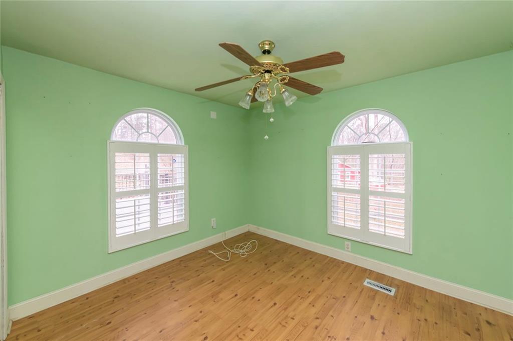 3819 Mason Creek Road Winston, GA 30187 - Photo 23 of 52 an empty room with windows and a ceiling fan