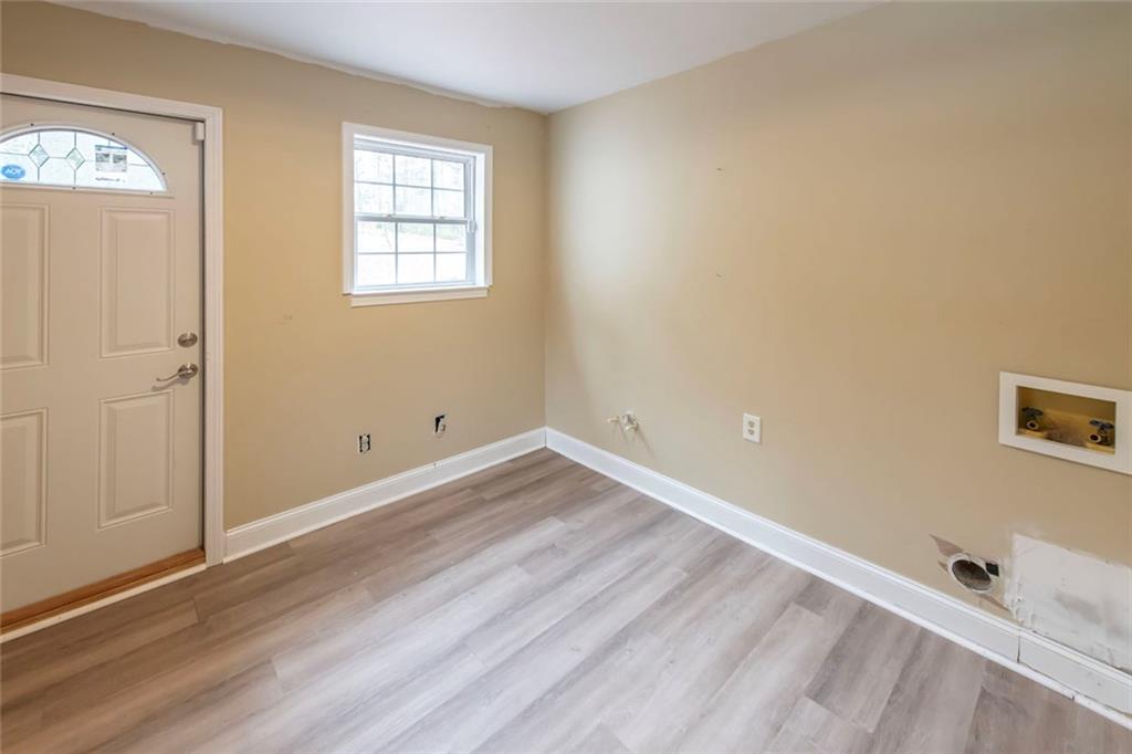 3819 Mason Creek Road Winston, GA 30187 - Photo 26 of 52 an empty room with wooden floor and windows