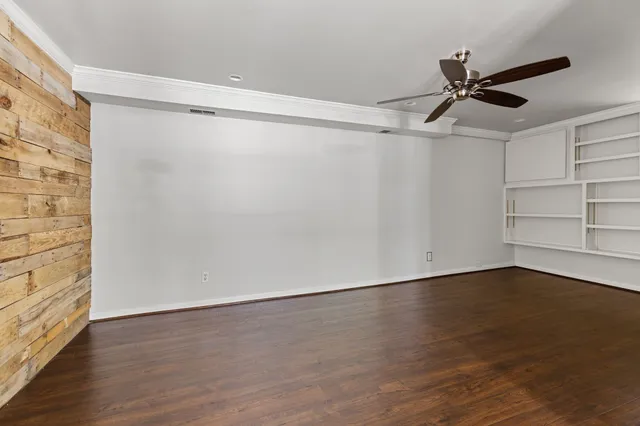 a view of a room with wooden floor closet and windows