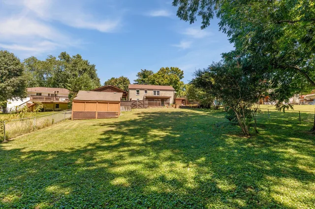 a backyard of a house with table and chairs