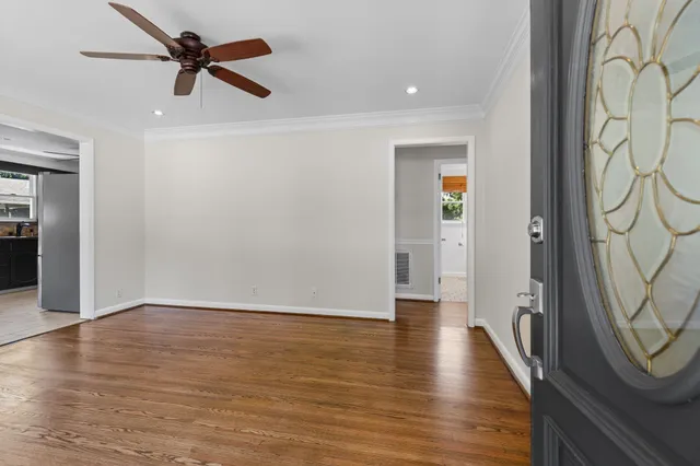 wooden floor in an empty room with a window