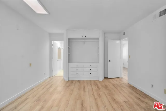 a bathroom with a granite countertop sink a mirror a vanity and bathtub