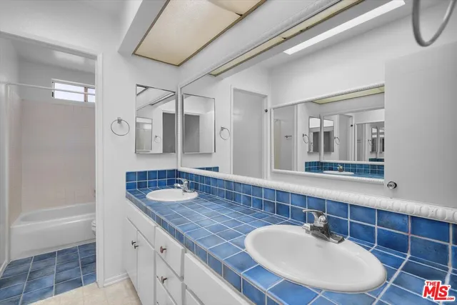 a bathroom with a bathtub and shower
