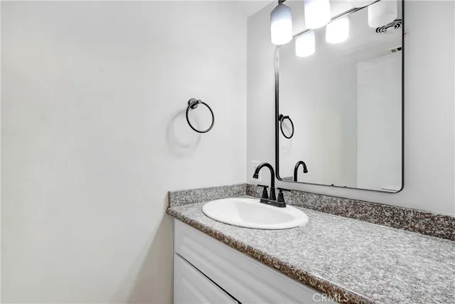 a sink with a mirror and vanity