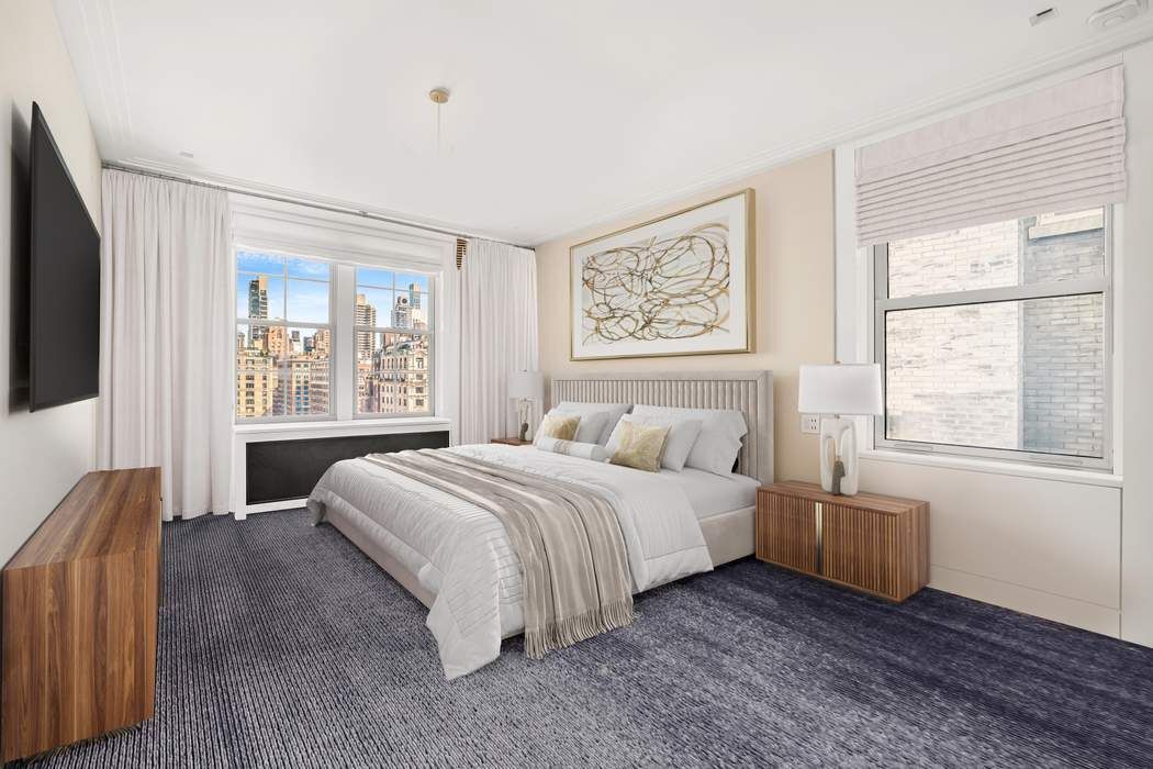 825 5th Avenue, Unit 12C Manhattan, NY 10065 - Photo 10 of 15 a bedroom with a bed and a large window