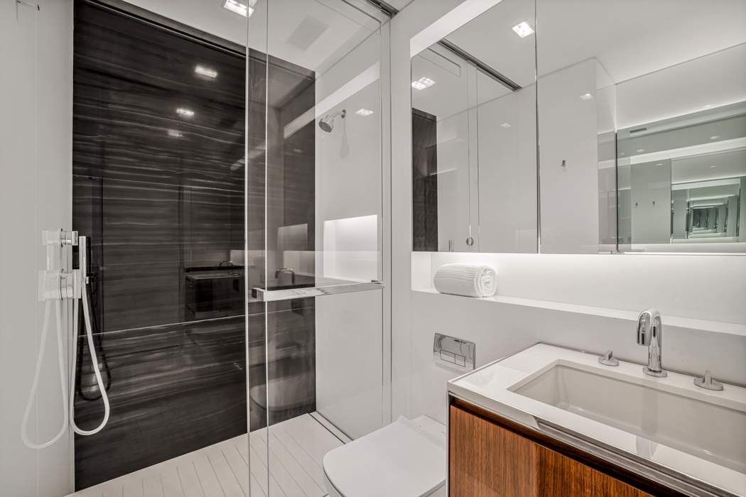 825 5th Avenue, Unit 12C Manhattan, NY 10065 - Photo 12 of 15 a bathroom with a sink a toilet and shower