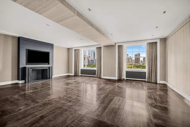 a view of an empty room with a fireplace and a window