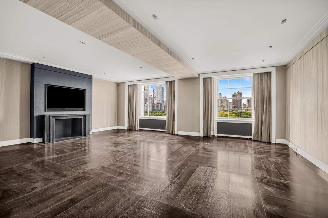 825 5th Avenue, Unit 12C Manhattan, NY 10065 - Photo 5 of 15 a view of an empty room with a fireplace and a window