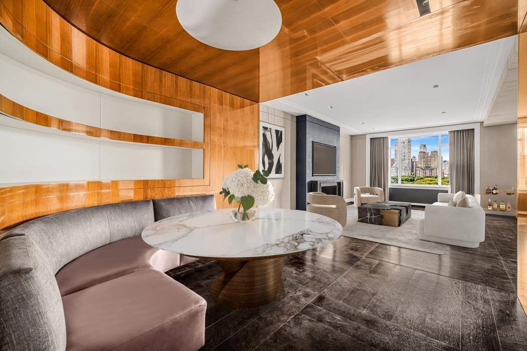 825 5th Avenue, Unit 12C Manhattan, NY 10065 - Photo 6 of 15 a living room with furniture and a lamp