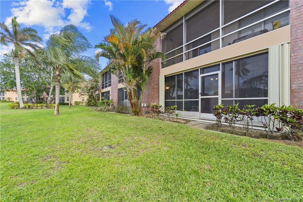 1941 Southwest Palm City Road, Unit B Stuart, FL 34994 - Photo 20 of 40 a view of a house with backyard porch and garden