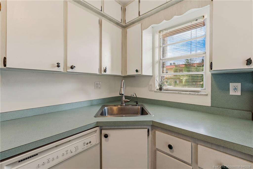 1941 Southwest Palm City Road, Unit B Stuart, FL 34994 - Photo 6 of 40 a kitchen with a sink cabinets and window