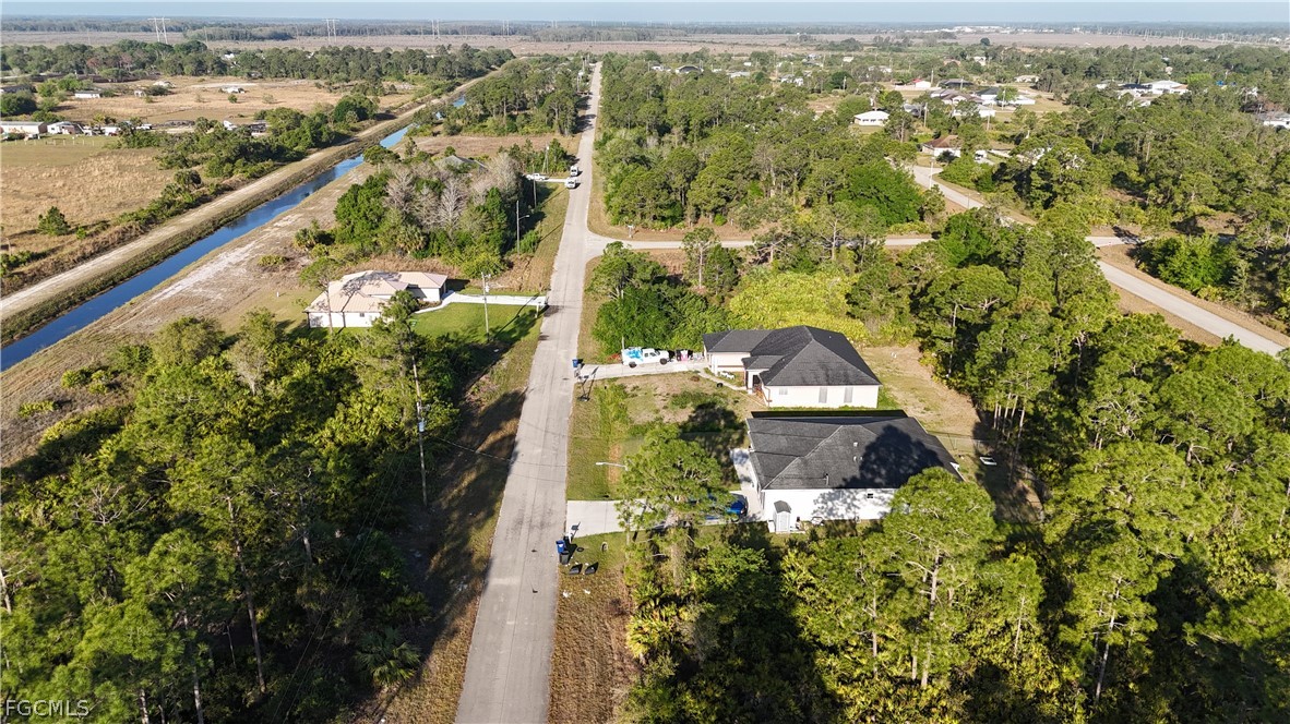 1251 Bermar Street Fort Myers, FL 33913 - Photo 14 of 20 an aerial view of a house with a yard and large trees