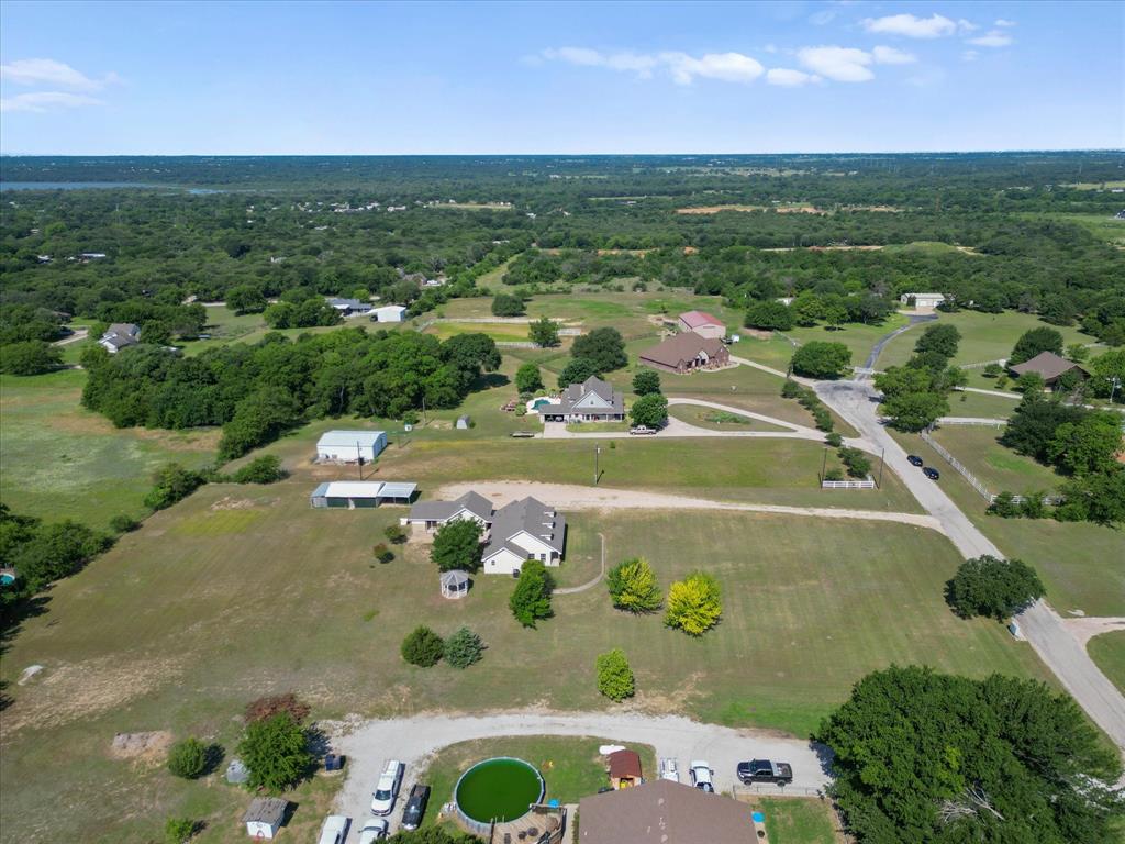 289 County Road 4655 Rhome, TX 76078 - Photo 30 of 34 Expansive aerial view showcasing multiple residential properties and a distant body of water