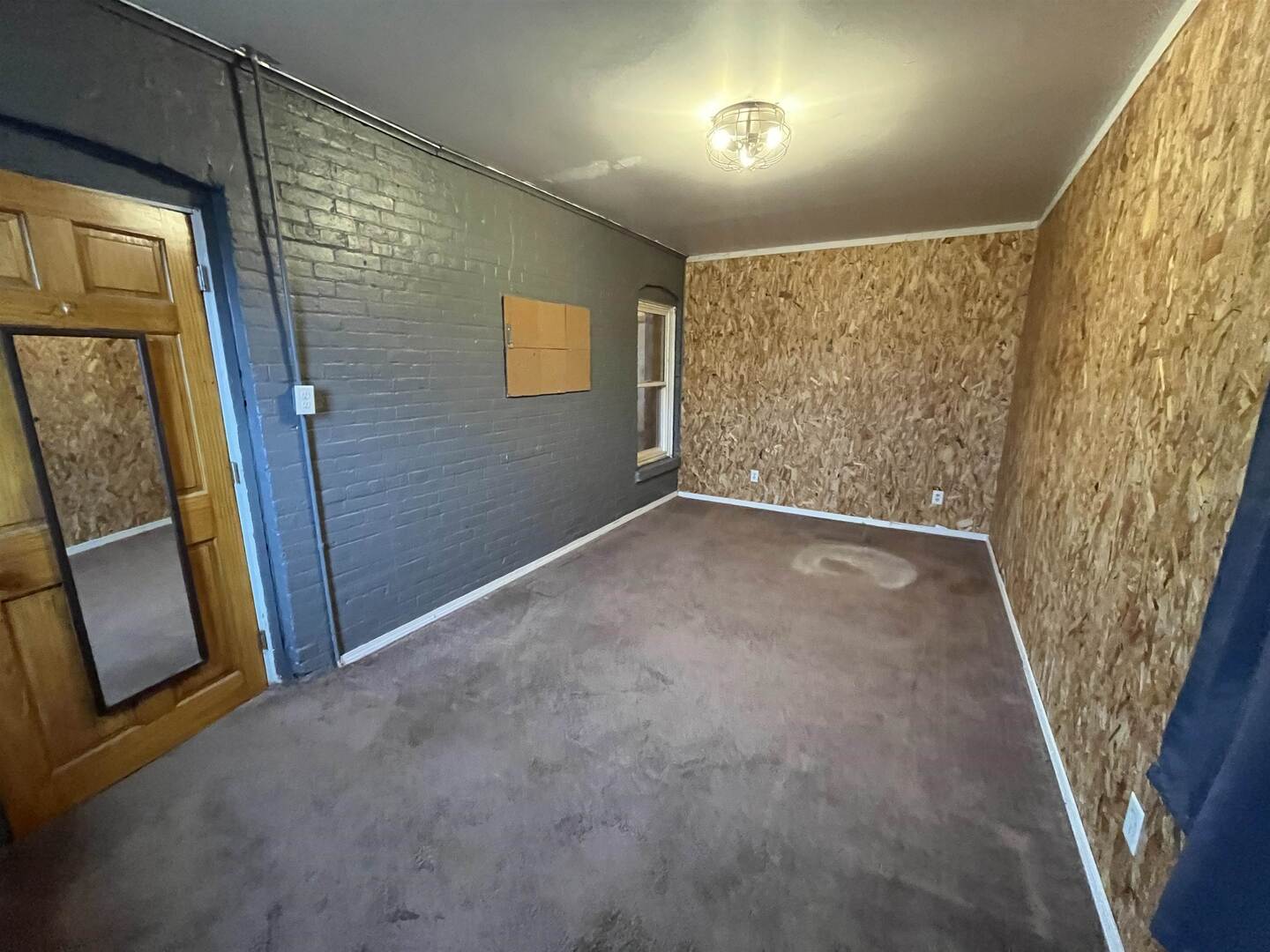 3302 Rockingham Road Davenport, IA 52802 - Photo 17 of 35 a view of an empty room with wooden floor and a window