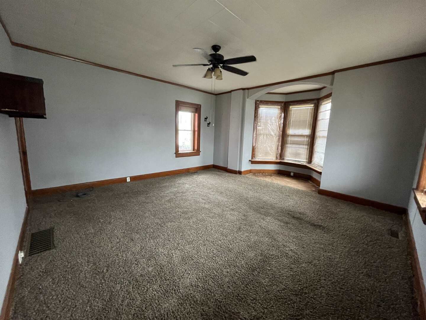 3302 Rockingham Road Davenport, IA 52802 - Photo 6 of 35 an empty room with windows and ceiling fan