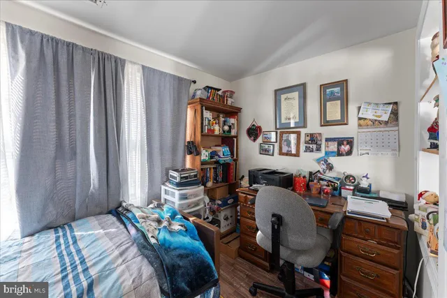 a bedroom with a bed and a bookshelf