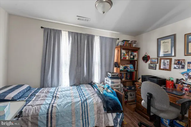 a bedroom that has a bed and a bookshelf in it