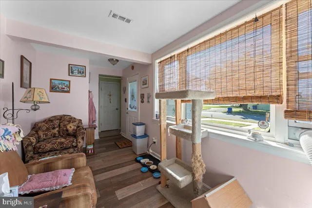 a living room with furniture and large windows