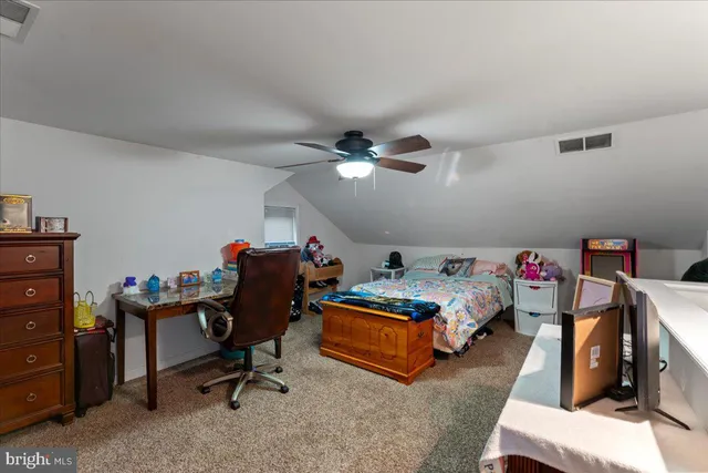 a bedroom with bed and a chandelier