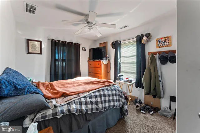 a bedroom with bed and a window