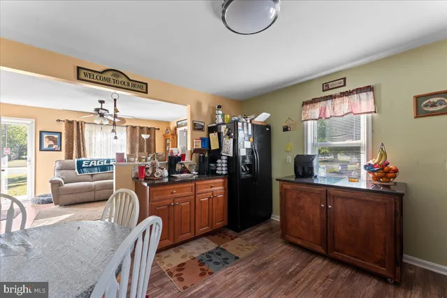 a kitchen with granite countertop a stove cabinets and wooden floor