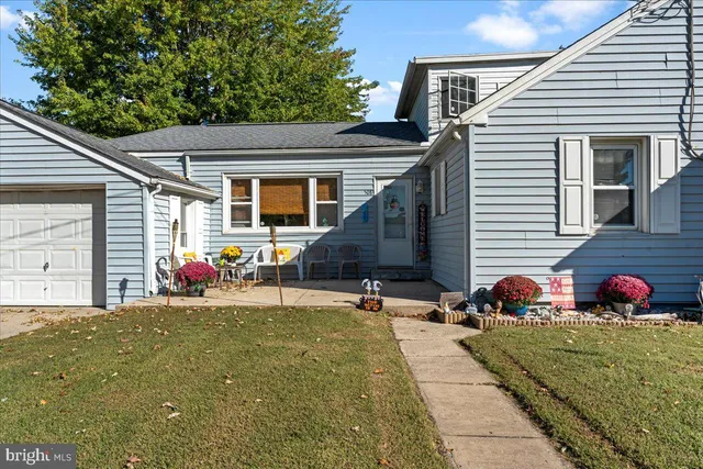 a backyard of a house with yard and outdoor seating