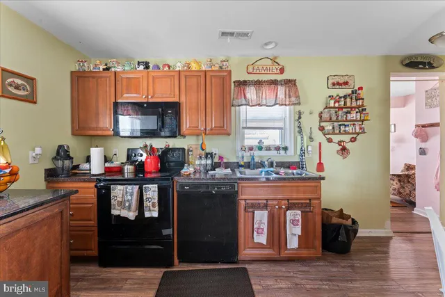 a kitchen with stainless steel appliances granite countertop a stove top oven a sink and dishwasher