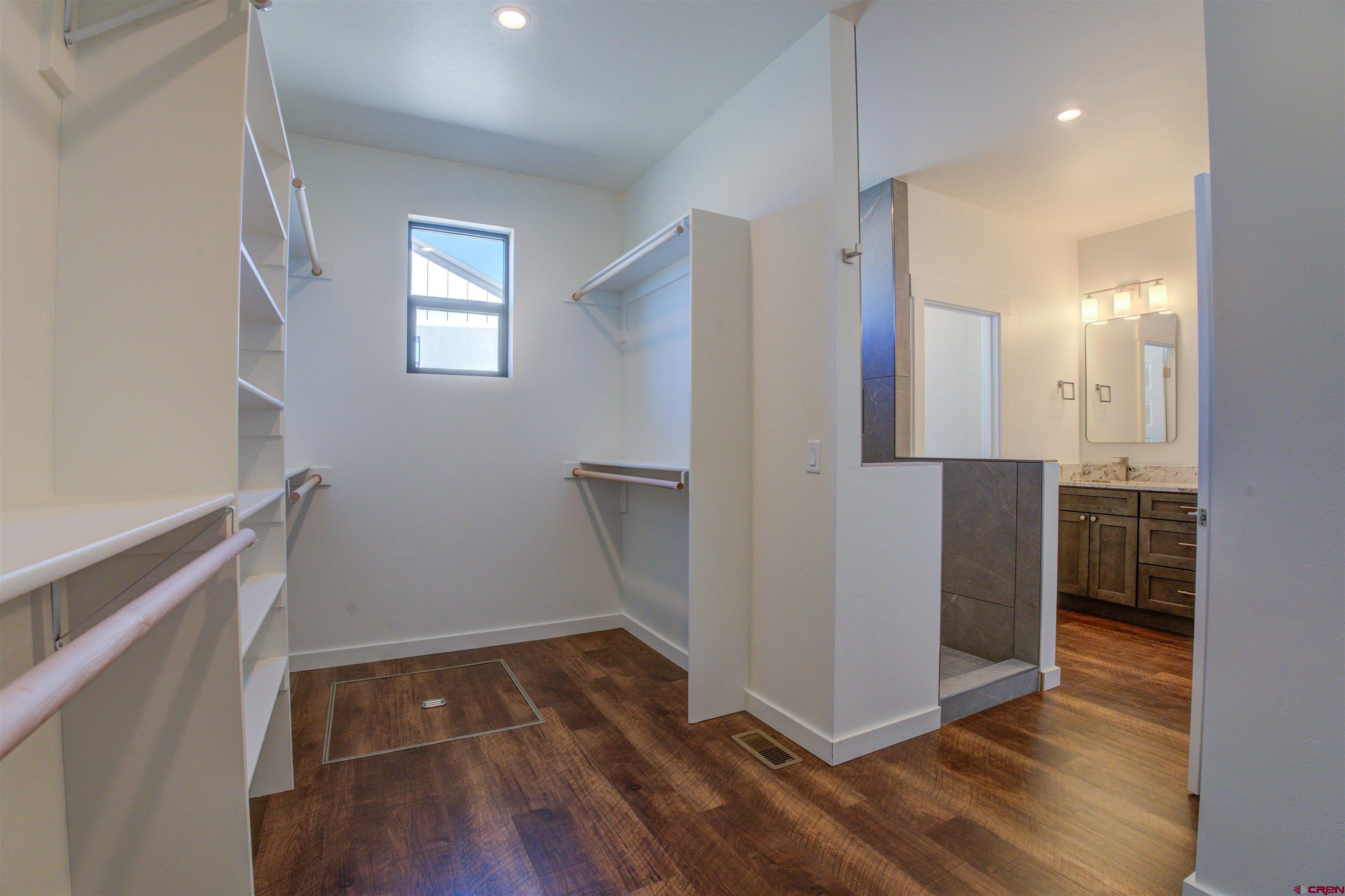 1678 Golf Course Lane Cortez, CO 81321 - Photo 14 of 28 a view of an empty room with wooden floor and a window