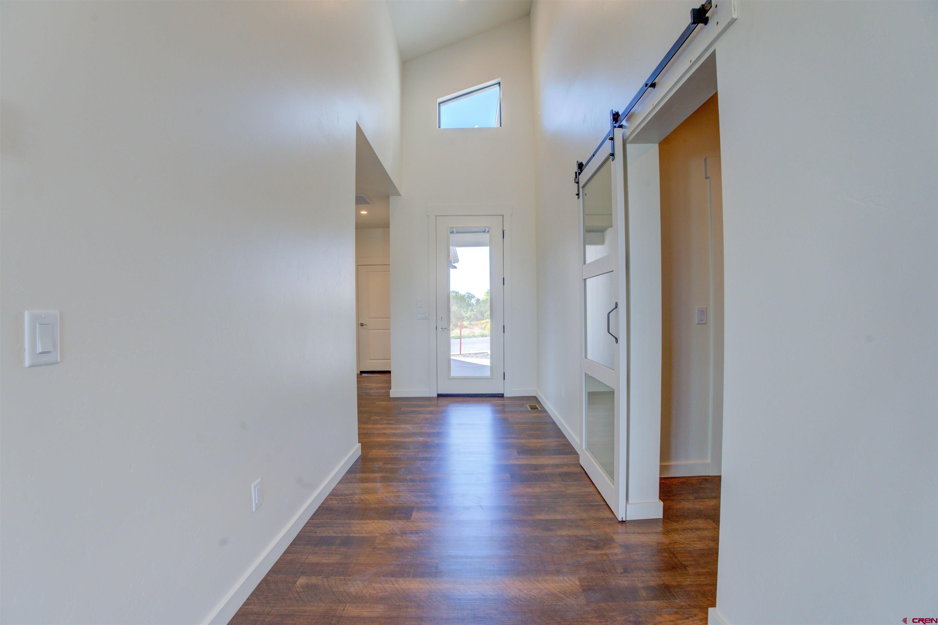 1678 Golf Course Lane Cortez, CO 81321 - Photo 15 of 28 a view of a hallway with wooden floor