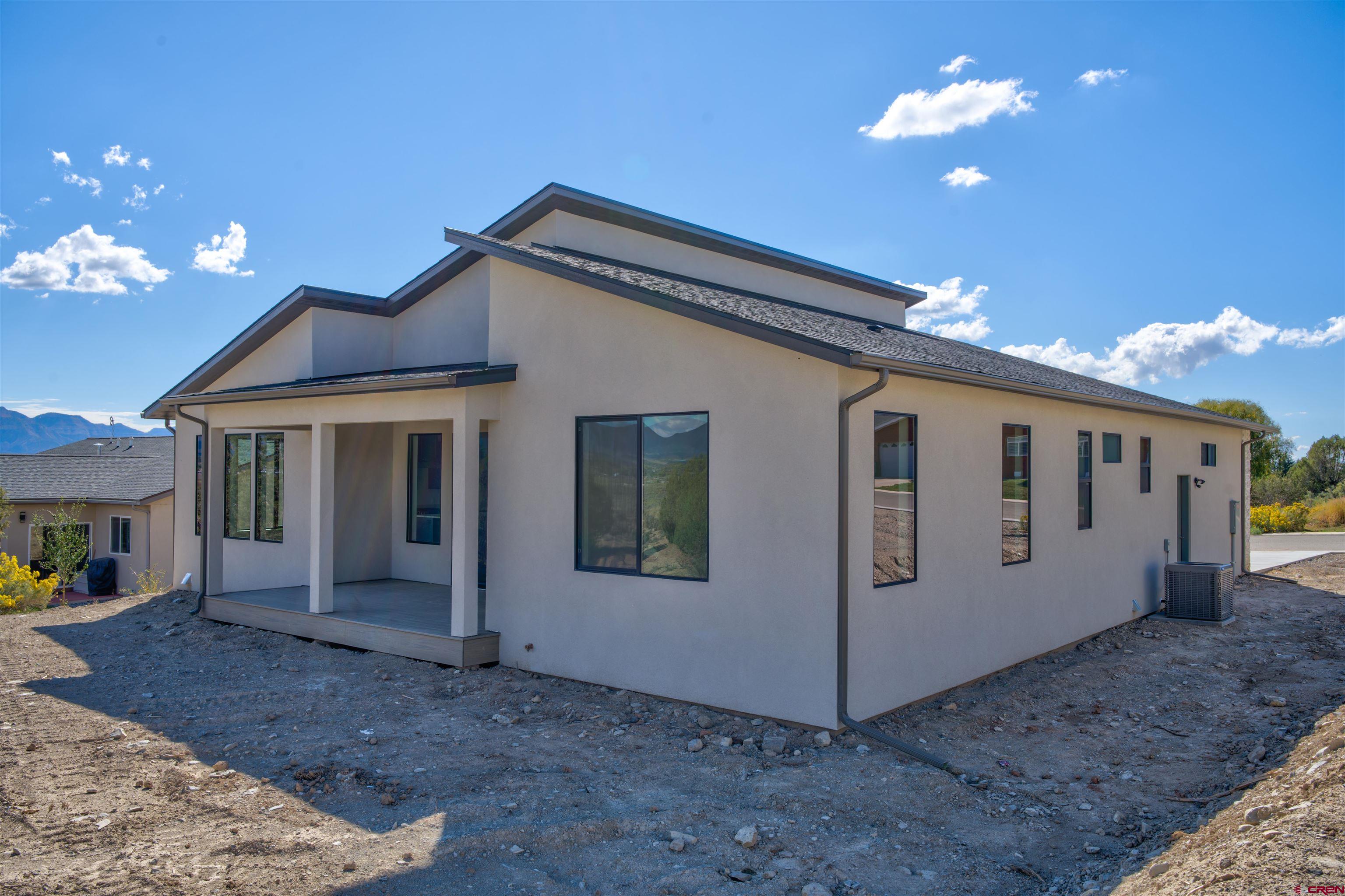 1678 Golf Course Lane Cortez, CO 81321 - Photo 23 of 28 a view of a house with a ceiling fan and a yard