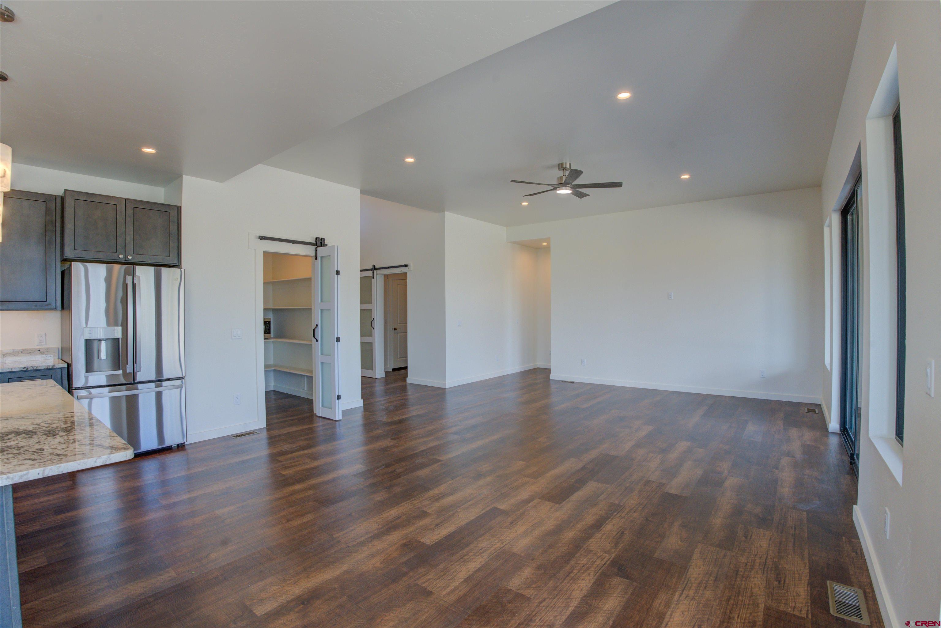 1678 Golf Course Lane Cortez, CO 81321 - Photo 28 of 28 a view of an empty room with a window and wooden floor
