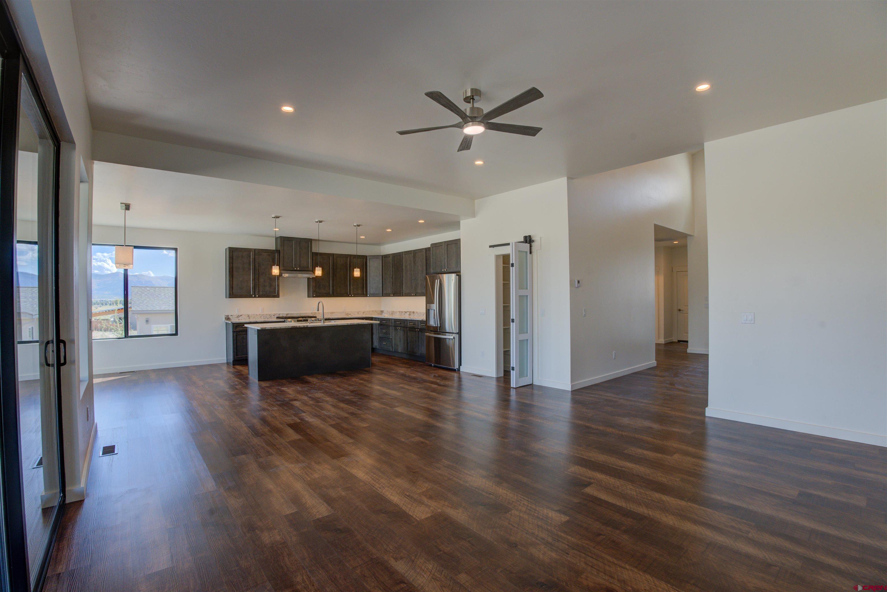 1678 Golf Course Lane Cortez, CO 81321 - Photo 6 of 28 a view of a kitchen with a sink cabinets and wooden floor