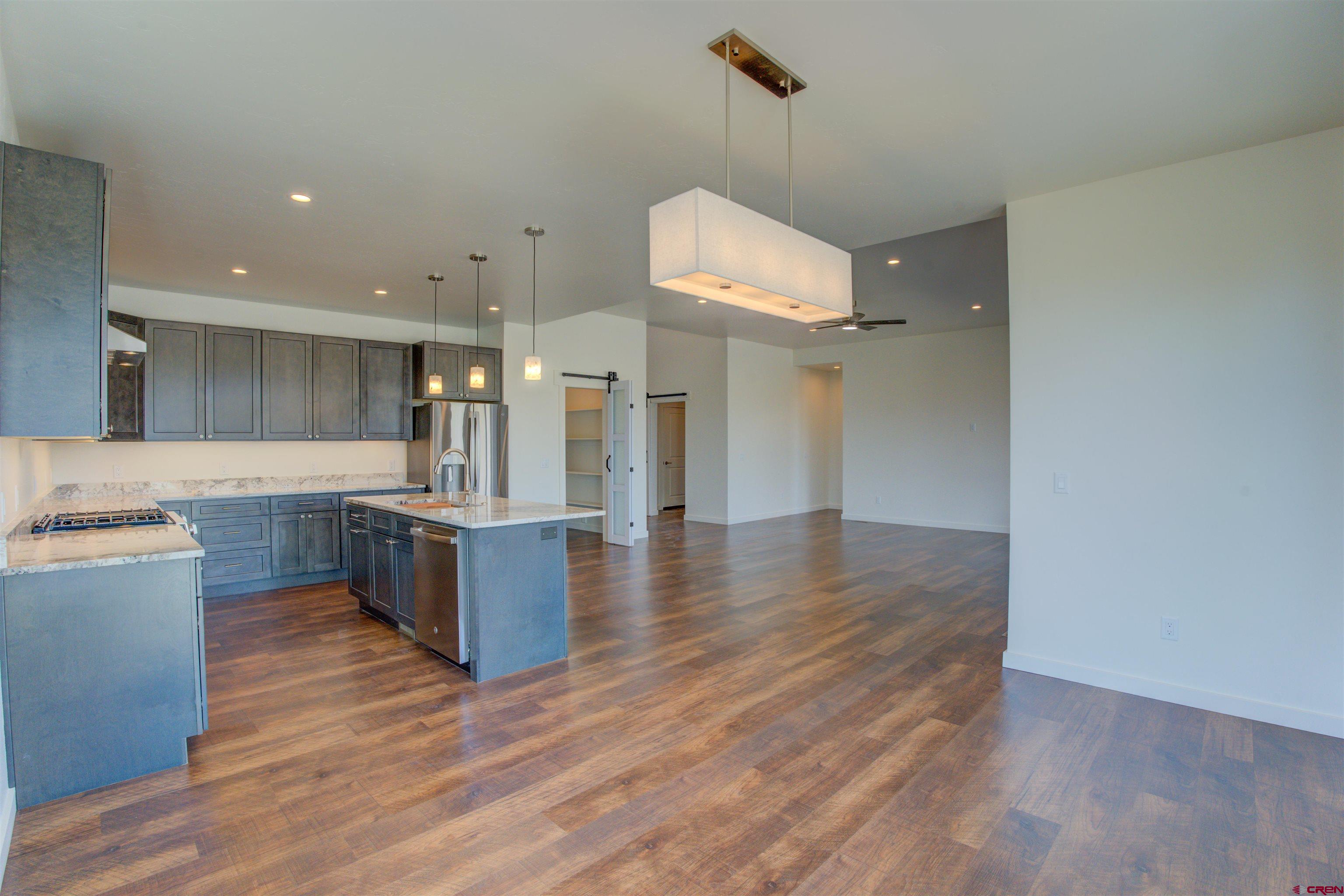 1678 Golf Course Lane Cortez, CO 81321 - Photo 8 of 28 a large kitchen with a lot of counter space and wooden floor