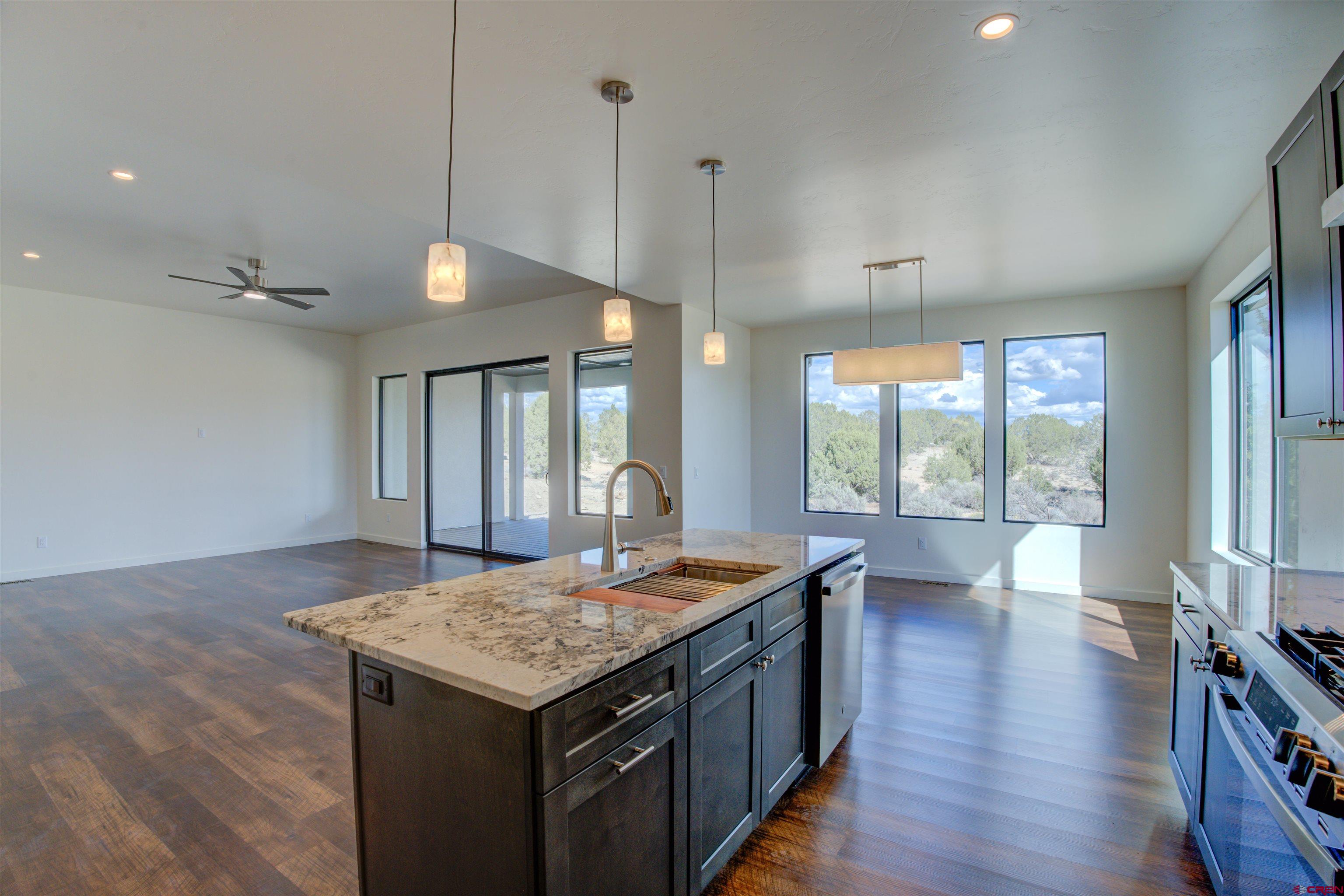 1678 Golf Course Lane Cortez, CO 81321 - Photo 9 of 28 a kitchen with a stove and a wooden floor