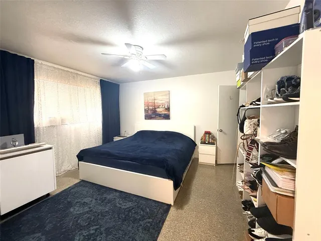 a living room with a bed furniture and a window