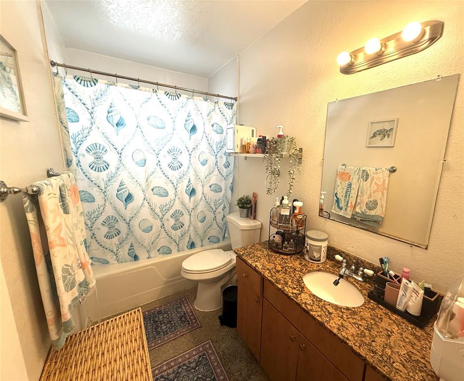 1441 Miami Road, Unit 1 Fort Lauderdale, FL 33316 - Photo 7 of 11 a bathroom with a granite countertop sink mirror vanity and toilet