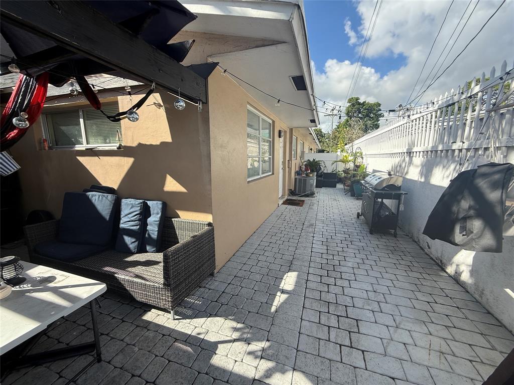 1441 Miami Road, Unit 1 Fort Lauderdale, FL 33316 - Photo 9 of 11 a outdoor space with lots of white furniture and shower